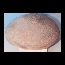 a-djenne-terracotta-vessel-in-the-form-of-a-hut,-with-all-over-incised-zigzag-and-straight-line-decoration,-the-top-with-six-perforations_t144b