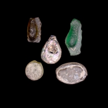 a-group-of-5-(five)-early-islamic-glass-vessel-stamps,-two-examples-moulded-in-the-form-of-a-human-face_08537c